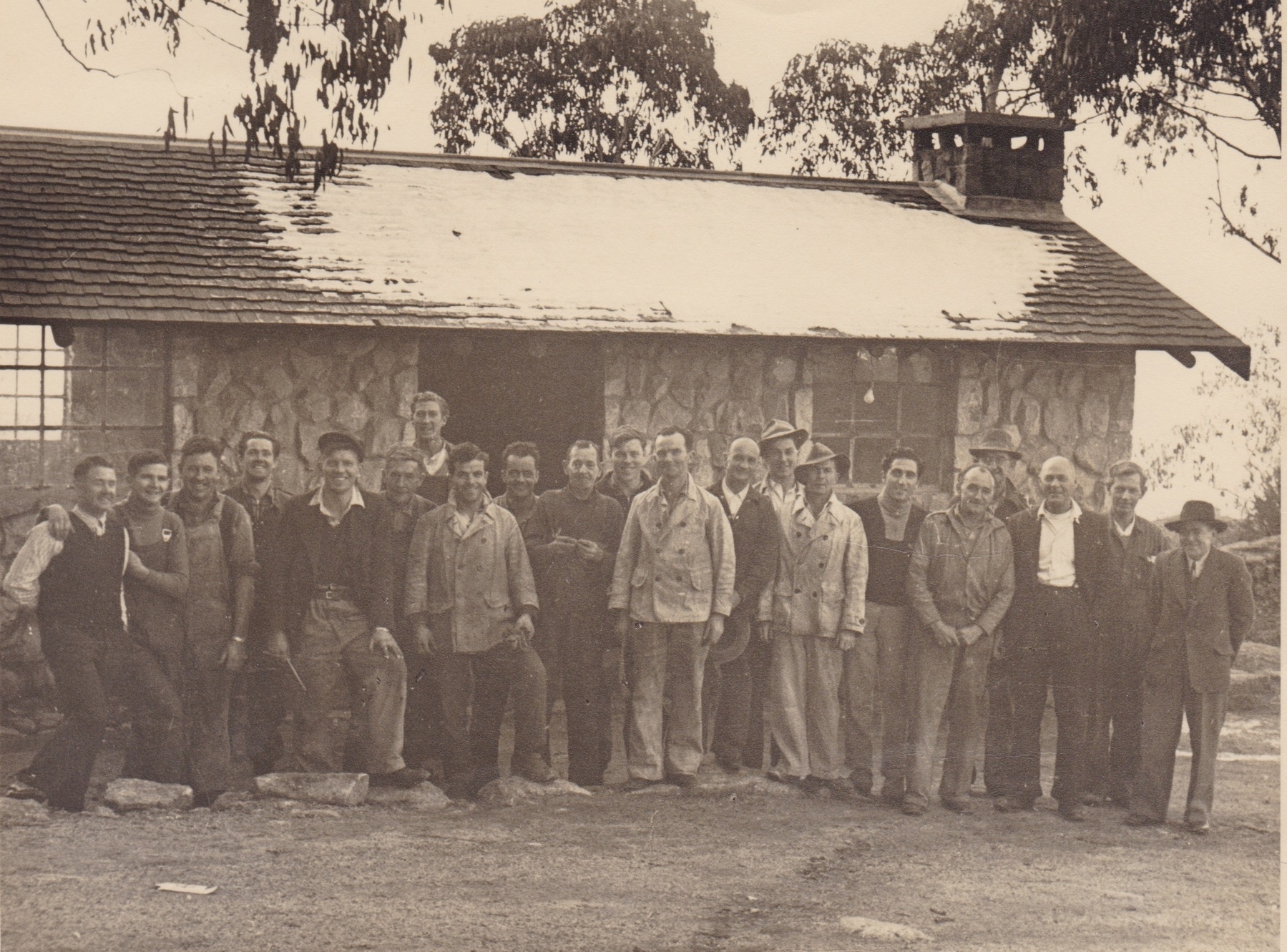 Railway tradesmen. Carpenters, plumbers, painters, tilers, and labourers. Photo taken at Echo Point, June 1952. Third from left: Les Merton, plumber. Back row right of door, myself, carpenter. Back row left of window, Allan Coulson, carpenter. Extreme right, engineer. Third from right, Leslie Brush, foreman carpenter.